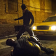 Daredevil standing over a criminal.
